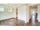 A bright dining room features wainscoting, tray ceilings, wood floors, and a modern chandelier at 2012 Embassy Ct # 46, Charlotte, NC 28213