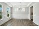 Spacious dining room featuring wainscoting, modern light fixture, and ample natural light at 2012 Embassy Ct # 46, Charlotte, NC 28213