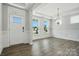 Bright entryway with hardwood floors, modern chandelier, and wainscoting along the walls at 2012 Embassy Ct # 46, Charlotte, NC 28213
