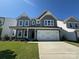 Charming two-story home with a well-manicured lawn, inviting front porch, and two-car garage for modern suburban living at 2012 Embassy Ct # 46, Charlotte, NC 28213