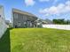 Backyard view of the home with an outdoor covered patio and white privacy fence at 2012 Embassy Ct # 46, Charlotte, NC 28213