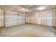 Unfinished garage with concrete floor and white garage door at 2012 Embassy Ct # 46, Charlotte, NC 28213