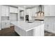 Modern kitchen featuring white cabinets, stainless steel appliances, and a large center island at 2012 Embassy Ct # 46, Charlotte, NC 28213