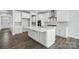 Bright kitchen featuring white cabinetry, a large center island, stainless steel appliances, and hardwood floors at 2012 Embassy Ct # 46, Charlotte, NC 28213