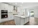 Bright kitchen showcasing a central island, stainless appliances, subway tile backsplash, and open layout at 2012 Embassy Ct # 46, Charlotte, NC 28213