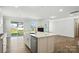 Open-concept kitchen and living room with stainless steel appliances and view of the backyard at 2012 Embassy Ct # 46, Charlotte, NC 28213