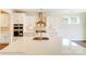 Stylish kitchen with white cabinets, a large island, stainless steel appliances, and modern fixtures at 2012 Embassy Ct # 46, Charlotte, NC 28213