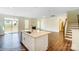 Bright kitchen island overlooking a fireplace and a staircase with wood and wrought iron at 2012 Embassy Ct # 46, Charlotte, NC 28213