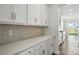 Stylish kitchen highlighting white countertops, cabinets, backsplash, and stainless steel hardware at 2012 Embassy Ct # 46, Charlotte, NC 28213