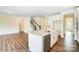 Kitchen island with stainless steel appliances overlooking a stairway and an open living area at 2012 Embassy Ct # 46, Charlotte, NC 28213
