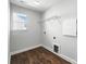 Laundry room with wood-look floors, a window, and utility connections at 2012 Embassy Ct # 46, Charlotte, NC 28213