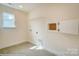 Bright laundry room with window, tiled floor, and convenient storage at 2012 Embassy Ct # 46, Charlotte, NC 28213