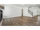 Spacious living room with hardwood floors, a fireplace, and a staircase leading to the upper level at 2012 Embassy Ct # 46, Charlotte, NC 28213