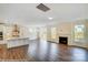 Open-concept living room next to kitchen with hardwood floors and a fireplace at 2012 Embassy Ct # 46, Charlotte, NC 28213