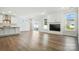 Open-concept living room and kitchen area with hardwood floors, fireplace, and sliding glass doors at 2012 Embassy Ct # 46, Charlotte, NC 28213
