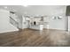 Open-concept living space with a modern kitchen featuring a large island and a staircase leading upstairs at 2012 Embassy Ct # 46, Charlotte, NC 28213