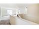 Upper-level loft area with staircase, neutral carpeting and ample natural light at 2012 Embassy Ct # 46, Charlotte, NC 28213