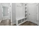 Functional mudroom area offering built-in bench, storage shelves, and coat hooks at 2012 Embassy Ct # 46, Charlotte, NC 28213