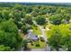 Lovely aerial view of a home surrounded by lush trees and a verdant landscape at 206 Montclair Dr, Locust, NC 28097