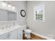 Bathroom with dual vanity, round mirror, and a clean, bright aesthetic at 206 Montclair Dr, Locust, NC 28097