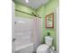Bathroom with a tub and shower, green painted walls, and a framed mirror at 206 Montclair Dr, Locust, NC 28097