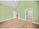 Bright bedroom with hardwood floors, white trim, and a green painted walls at 206 Montclair Dr, Locust, NC 28097