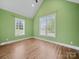 Well-lit bedroom with hardwood floors, a vaulted ceiling, and a bright green paint at 206 Montclair Dr, Locust, NC 28097