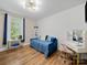 Charming bedroom with a blue daybed, vanity desk, and bright natural light from the window at 206 Montclair Dr, Locust, NC 28097