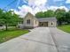 Charming single-story home with a long driveway, manicured lawn, and a covered porch at 206 Montclair Dr, Locust, NC 28097
