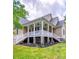 Inviting home featuring a charming front porch with classic railings and stone accents at 206 Montclair Dr, Locust, NC 28097