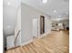 Bright hallway featuring wood floors, recessed lighting, and a view into the main bedroom at 206 Montclair Dr, Locust, NC 28097