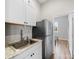 Kitchenette equipped with stainless steel appliances, sink, white cabinetry, and modern countertops at 206 Montclair Dr, Locust, NC 28097