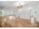 Open-concept living space featuring hardwood floors, modern lighting, and neutral paint at 206 Montclair Dr, Locust, NC 28097
