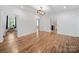 Bright living area with hardwood floors and multiple doorways for easy flow throughout the home at 206 Montclair Dr, Locust, NC 28097