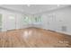 Bright living room with hardwood floors, white trim, and large windows for plenty of light at 206 Montclair Dr, Locust, NC 28097