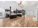 Spacious open concept living room and kitchen with hardwood floors and stainless steel appliances at 206 Montclair Dr, Locust, NC 28097