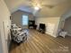 Cozy living space with a window, ceiling fan, and two accent chairs at 206 Montclair Dr, Locust, NC 28097