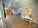 Open living space featuring laminate floors, bright lighting, and neutral colored walls at 206 Montclair Dr, Locust, NC 28097