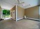 Covered patio with a ceiling fan, stone accents, and an open view of the backyard at 206 Montclair Dr, Locust, NC 28097