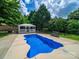 This in-ground pool and gazebo create an inviting outdoor oasis at 206 Montclair Dr, Locust, NC 28097