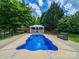 This in-ground pool and gazebo create an inviting outdoor oasis at 206 Montclair Dr, Locust, NC 28097