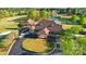 Aerial view of the golf course clubhouse surrounded by lush greenery and a pond at 2119 Augusta National Dr, Denver, NC 28037