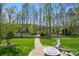 Landscaped backyard offers a brick pathway leading to a stone fire pit at 2119 Augusta National Dr, Denver, NC 28037
