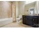 Bathroom featuring granite vanity, tiled shower with curtain, and updated fixtures at 2119 Augusta National Dr, Denver, NC 28037
