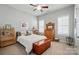 Cozy bedroom with ample lighting, wood floors, bright walls and a large bed at 2119 Augusta National Dr, Denver, NC 28037