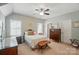 Bright bedroom featuring a cozy bed, shuttered windows, and elegant furnishings at 2119 Augusta National Dr, Denver, NC 28037