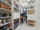 Organized walk-in closet with built-in shelving, drawers, and ample storage space at 2119 Augusta National Dr, Denver, NC 28037