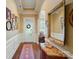 Elegant foyer with hardwood floors, decorative mirror, and a view of the front door and entryway at 2119 Augusta National Dr, Denver, NC 28037