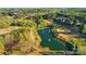 Scenic aerial view of the lush golf course featuring a tranquil pond with fountains at 2119 Augusta National Dr, Denver, NC 28037