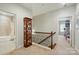 Hallway with hardwood floors, a decorative cabinet, and doorways leading to other rooms at 2119 Augusta National Dr, Denver, NC 28037